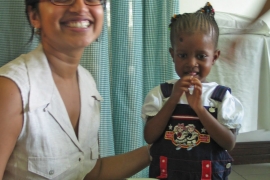 Portrait of Sumathi Sivapalasingam '90 and a child